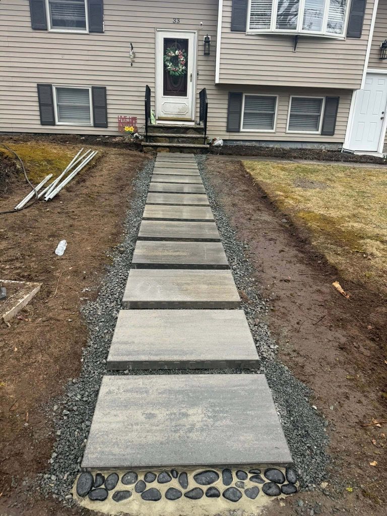 modern paver walkway design with concrete slabs and gravel base installation