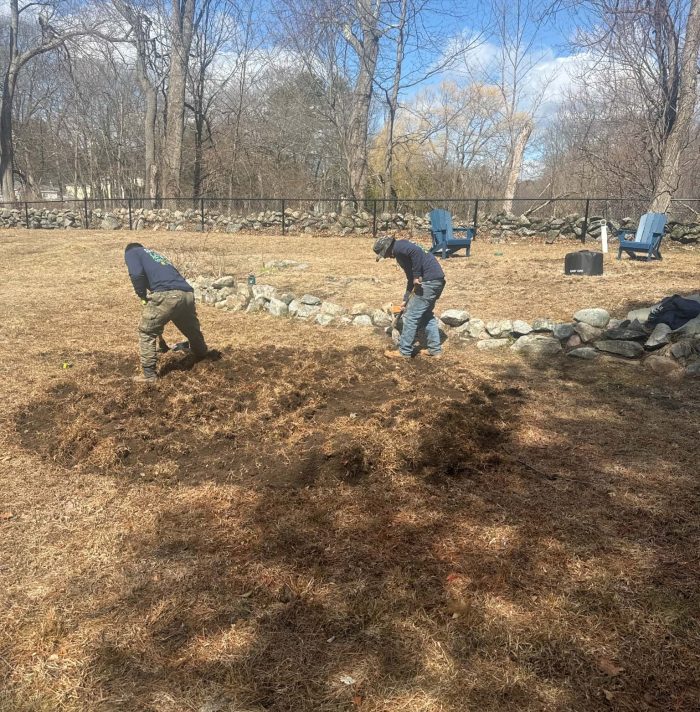 Grounds of Nature Landscaping Inc. preparing a landscape bed for new plant installation and soil improvement.