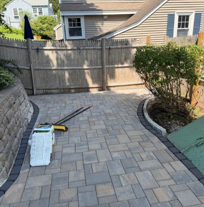 Newly installed paver patio featuring decorative border edging that enhances stability and creates a clean, finished appearance.